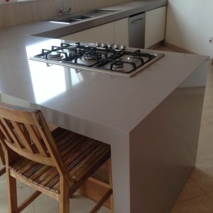 Pia, Ilha e Bancada com Empena e Cooktop Embutido em Quartzo Cinza